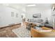 Spacious living room with a cozy sitting area, a large rug, and abundant natural light at 5193 S Flanders Ln, Centennial, CO 80015