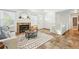 Bright living room features a fireplace, neutral decor and a staircase leading to a lower level at 5193 S Flanders Ln, Centennial, CO 80015