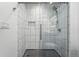 Updated shower features new glass doors, sleek tile, and modern fixtures at 5193 S Flanders Ln, Centennial, CO 80015