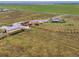 Aerial view of the property including the house, garages, and fenced-in area at 47855 E 88Th Ave, Bennett, CO 80102