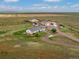 An aerial view showcasing the home, garages, and surrounding land at 47855 E 88Th Ave, Bennett, CO 80102