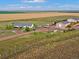 Aerial view of property showing house, garages, other vehicles, and open land at 47855 E 88Th Ave, Bennett, CO 80102