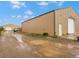 Barn exterior shot with gravel driveway and loading door, ideal for equipment storage and accessibility at 47855 E 88Th Ave, Bennett, CO 80102