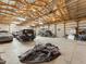 Interior view of the barn, large open space suitable for equipment storage, with wood beams at 47855 E 88Th Ave, Bennett, CO 80102
