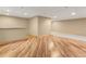 Basement area with laminate flooring, bar area with tiled countertop, and carpeted sitting area at 47855 E 88Th Ave, Bennett, CO 80102