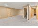 Large basement with neutral walls, plush carpet, and multiple doorways offering versatility and space at 47855 E 88Th Ave, Bennett, CO 80102