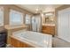 Inviting bathroom featuring a soaking tub with wood accents, a separate shower, and a vanity area at 47855 E 88Th Ave, Bennett, CO 80102