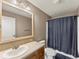 Functional bathroom with a vanity, toilet, and a shower/tub combination with a curtain at 47855 E 88Th Ave, Bennett, CO 80102