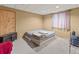Cozy bedroom with neutral colors, plush carpet, and natural light, ideal for relaxation at 47855 E 88Th Ave, Bennett, CO 80102