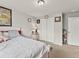 Bedroom with neutral walls, plush carpet, a comfortable bed, and a closet for storage at 47855 E 88Th Ave, Bennett, CO 80102