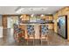 Inviting kitchen featuring a breakfast bar and warm, natural wood cabinetry at 47855 E 88Th Ave, Bennett, CO 80102