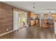 Open kitchen featuring a breakfast bar, wood cabinets, and sliding door access to the backyard at 47855 E 88Th Ave, Bennett, CO 80102