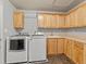Functional laundry room with modern washer and dryer, sink, and plenty of cabinet space at 47855 E 88Th Ave, Bennett, CO 80102