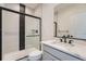 Modern bathroom with a glass shower, gray vanity, and black accents at 960 Superior Dr, Superior, CO 80027