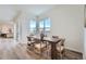 Bright dining area with wood table, six chairs, and large windows overlooking the backyard at 960 Superior Dr, Superior, CO 80027