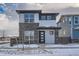 Two-story modern home with stone and siding exterior, welcoming front porch, and attached garage at 960 Superior Dr, Superior, CO 80027