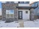 Modern front entrance with stone accents, glass door, and a welcoming stoop at 960 Superior Dr, Superior, CO 80027