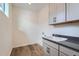Laundry room with gray cabinets and a built-in sink at 960 Superior Dr, Superior, CO 80027