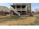 Exterior showcasing a multi-level deck and patio with stone accents and outdoor seating at 27596 E Jamison Cir, Aurora, CO 80016