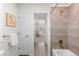 Tiled bathroom with a bathtub, shower, and access to another room and a doorway at 27596 E Jamison Cir, Aurora, CO 80016