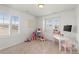 Bright bedroom with large windows, a dollhouse, and a play table and chairs at 27596 E Jamison Cir, Aurora, CO 80016