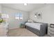 Comfortable bedroom with a trundle bed, carpeted floors, and sunny shuttered window at 27596 E Jamison Cir, Aurora, CO 80016