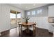 Cozy dining area with a round table, natural light, and access to the outdoor deck at 27596 E Jamison Cir, Aurora, CO 80016