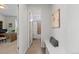 Hallway view to office and bathroom featuring neutral paint, white trim, and tile flooring at 27596 E Jamison Cir, Aurora, CO 80016