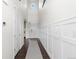 Bright and airy hallway with high ceilings, decorative wainscoting, and hardwood floors at 27596 E Jamison Cir, Aurora, CO 80016