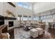 Inviting living room featuring a stone fireplace, lots of natural light, and stylish decor, ideal for relaxation and entertaining at 27596 E Jamison Cir, Aurora, CO 80016