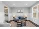 Comfortable living room featuring stylish decor, wainscoting, and a large window at 27596 E Jamison Cir, Aurora, CO 80016