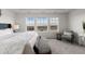 Bright main bedroom with comfortable seating, large windows, and plush carpet, a perfect sanctuary at 27596 E Jamison Cir, Aurora, CO 80016