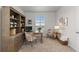 Well-lit home office with ample storage, featuring a classic desk, neutral carpet, and a serene atmosphere at 27596 E Jamison Cir, Aurora, CO 80016