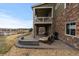 Exterior view of patio with stone accents and outdoor seating, overlooking scenic views at 27596 E Jamison Cir, Aurora, CO 80016