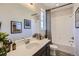 Bathroom showcasing a modern vanity, quartz countertop, and decorative fixtures, with tub shower combo at 1350 Loraine N Cir, Lafayette, CO 80026