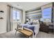 Bedroom with blue accent wall, baseball themed décor, bench seating, and plenty of natural light at 1350 Loraine N Cir, Lafayette, CO 80026