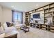 Comfortable living room featuring a large sectional sofa, custom built-in shelving, and modern decor at 1350 Loraine N Cir, Lafayette, CO 80026