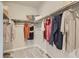 Spacious walk-in closet with ample storage space and neutral carpeting, featuring organized clothing at 1350 Loraine N Cir, Lafayette, CO 80026