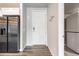 Welcoming entryway adjacent to a stainless steel refrigerator and in-unit washer and dryer at 9283 Twenty Mile Rd # 207, Parker, CO 80134