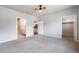 Spacious bedroom featuring a ceiling fan, neutral walls, and multiple doors that lead to other rooms in the house at 9283 Twenty Mile Rd # 207, Parker, CO 80134