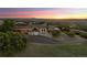 Luxury home with circular driveway, mountain views, and sunset at 1708 Creedmoor Ct, Castle Rock, CO 80109