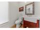 Powder room with a pedestal sink and wooden cabinet at 1708 Creedmoor Ct, Castle Rock, CO 80109