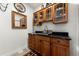 Laundry room with wooden cabinets and granite countertop at 1708 Creedmoor Ct, Castle Rock, CO 80109