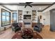 Living room features a fireplace, leather armchairs, and a large TV at 1708 Creedmoor Ct, Castle Rock, CO 80109