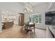 Bright dining area featuring a modern chandelier, wood table with seating for four, and views of the outdoors at 41 Eagle Dr, Littleton, CO 80123