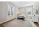 Bright bedroom with white metal frame bed, neutral walls, and elegant French doors at 2034 Dahlia St # 1, Denver, CO 80207