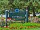 Welcoming City Park sign surrounded by vibrant flowers and lush greenery at 2034 Dahlia St # 1, Denver, CO 80207