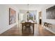 Open dining room featuring hardwood floors and a long wooden table with seating at 2034 Dahlia St # 1, Denver, CO 80207