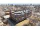 Aerial shot showcasing this brick apartment building, highlighting its layout and surrounding landscape at 2034 Dahlia St # 1, Denver, CO 80207