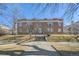 Classic brick apartment building showcasing front entrance, landscaping, and symmetrical design at 2034 Dahlia St # 1, Denver, CO 80207